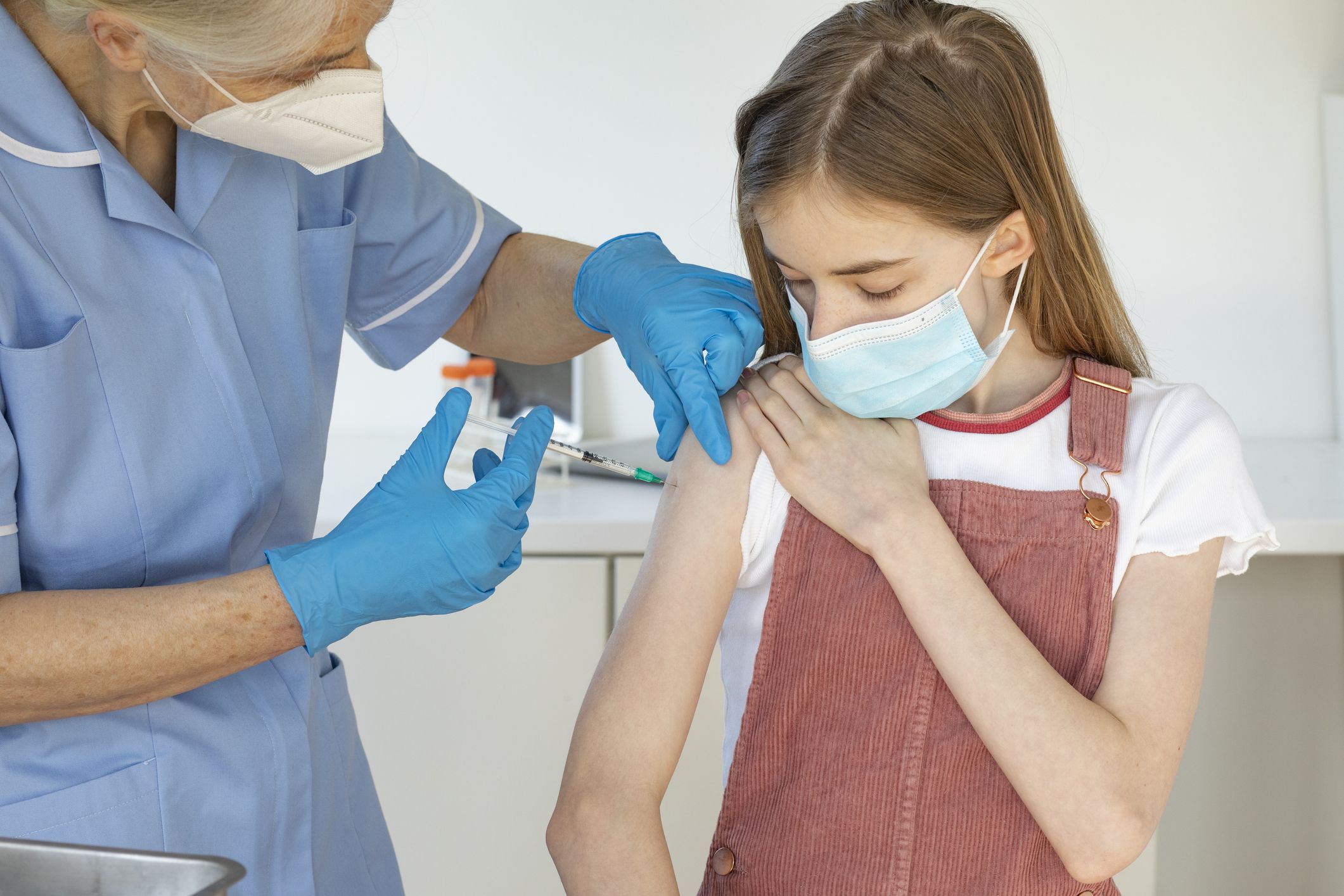 mature-nurse-giving-out-covid-vaccine-royalty-free-image-1632493275.jpg